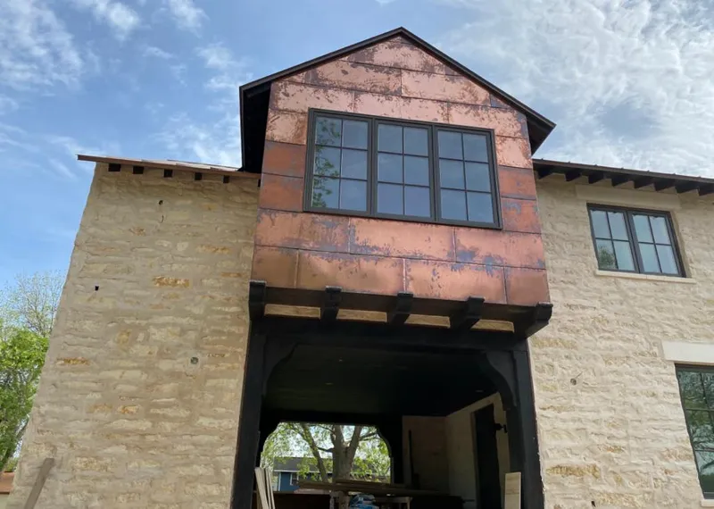 Copper metal panel facade on a stone building for Roof Repair in Paramus