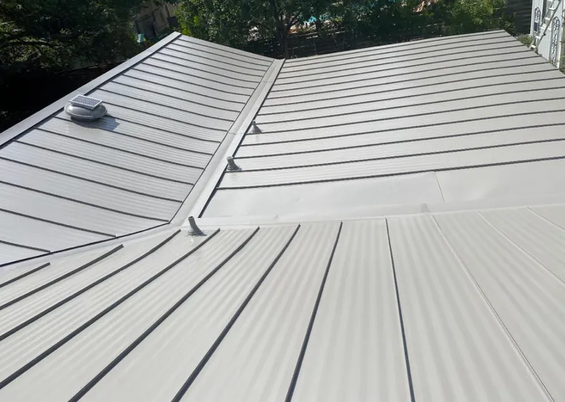 Solar attic fan installed on a metal roof for Roof Ventilation in Paramus
