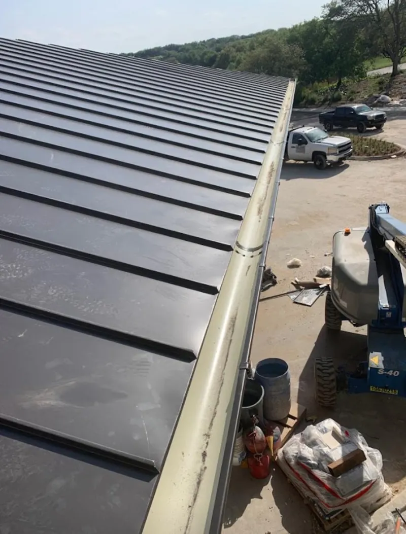 Standing seam panel and gutter detail on a metal roofing jobsite in Paramus
